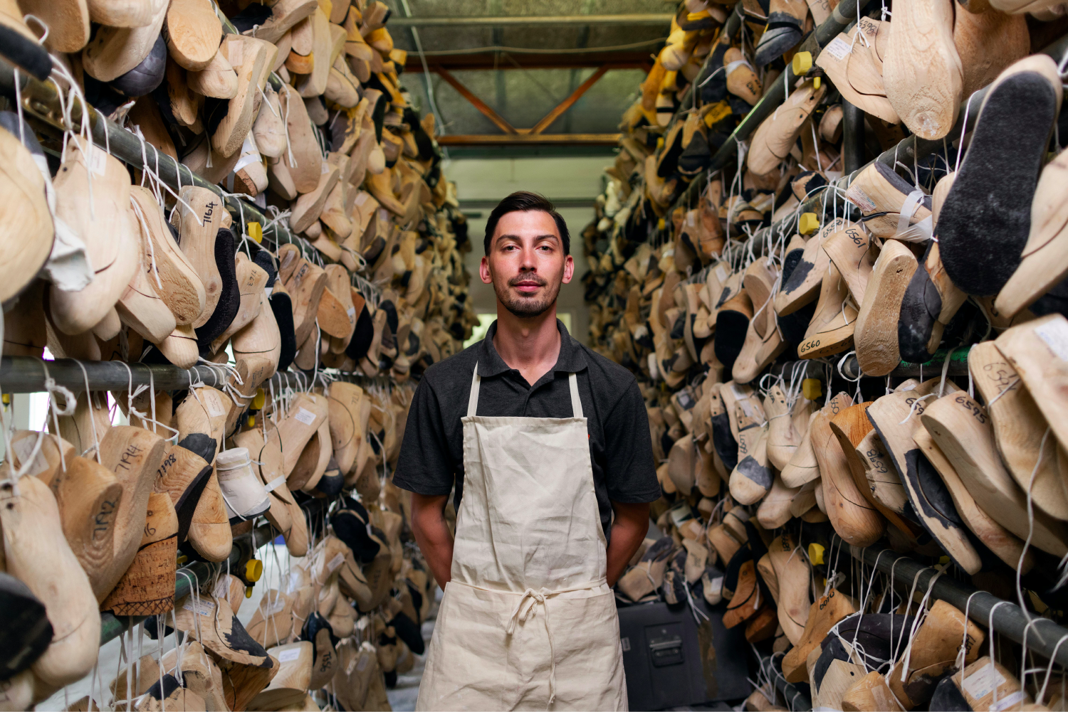 Male shoemaker with his wooden shoe forms.